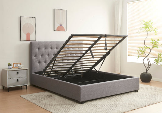 Gray upholstered bed with black metal frame in a bedroom setting.