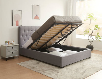 Gray upholstered bed with raised headboard in a bedroom setting.