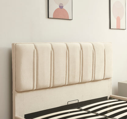 Beige upholstered headboard on a bed with striped bedding, framed artwork on the wall.