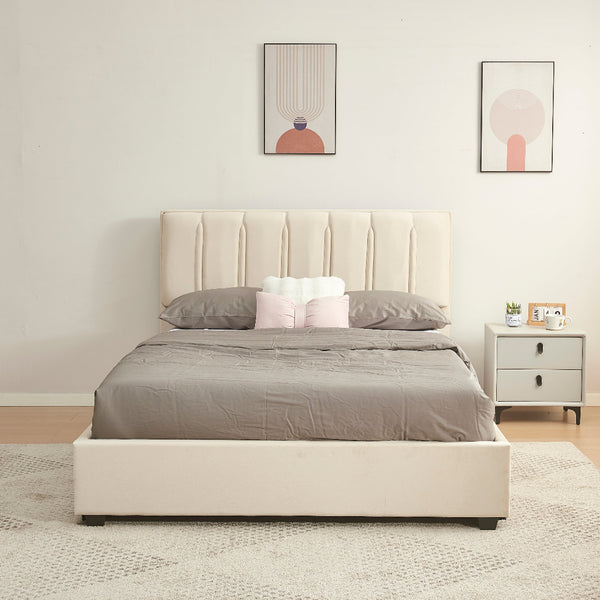 Beige upholstered bed with gray bedding in a bedroom setting.